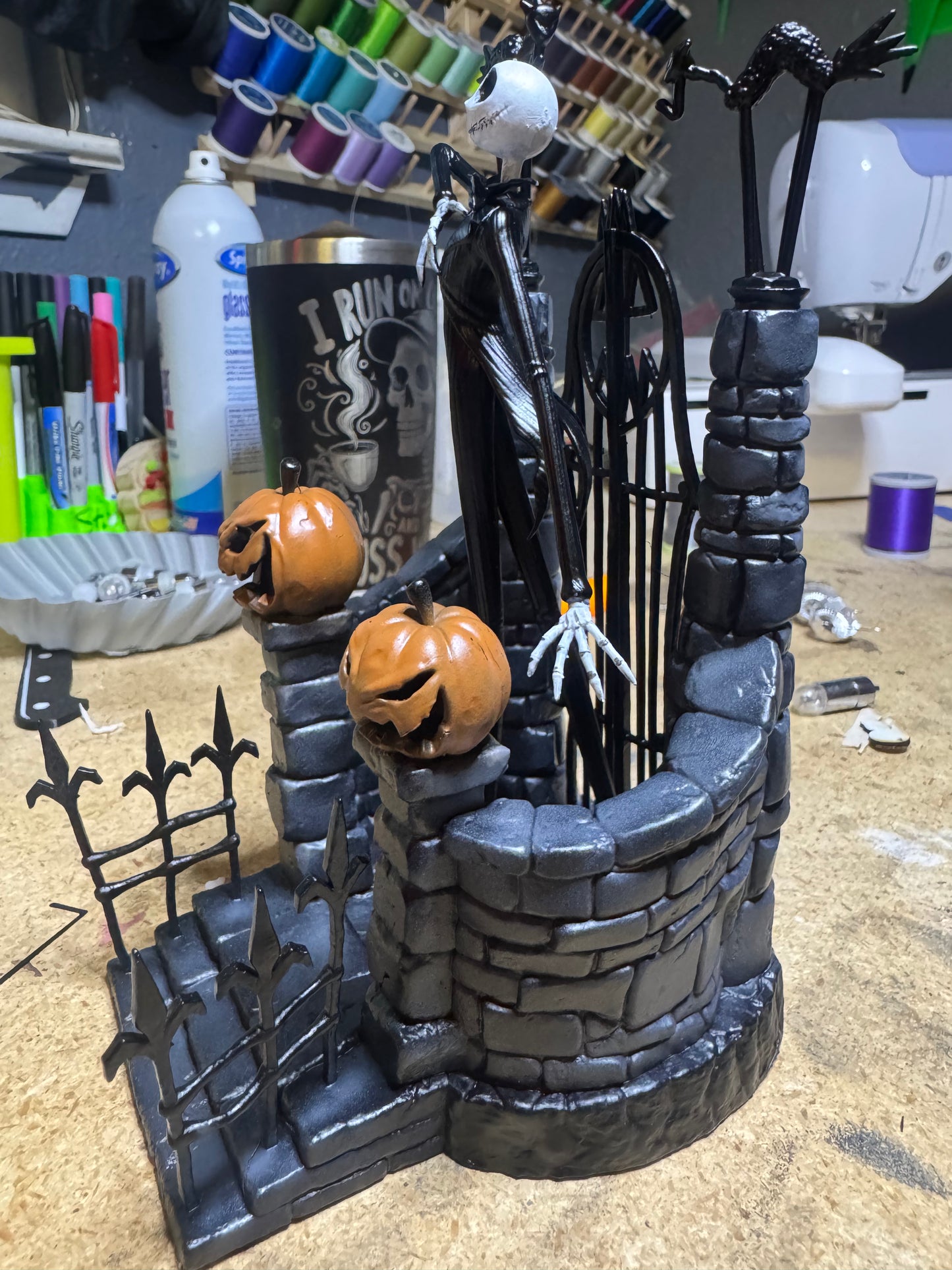 Side angle of 7-inch Jack Skellington collectible, showing detailed haunted gate and pumpkins