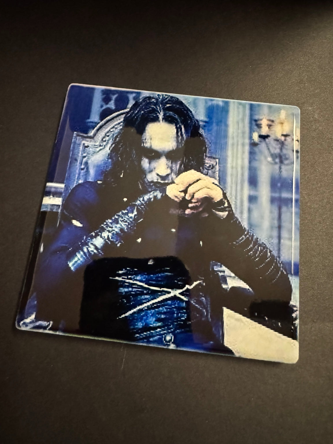 Square ceramic gothic horror coaster featuring a pale long-haired figure in dark clothing against a blue-toned background