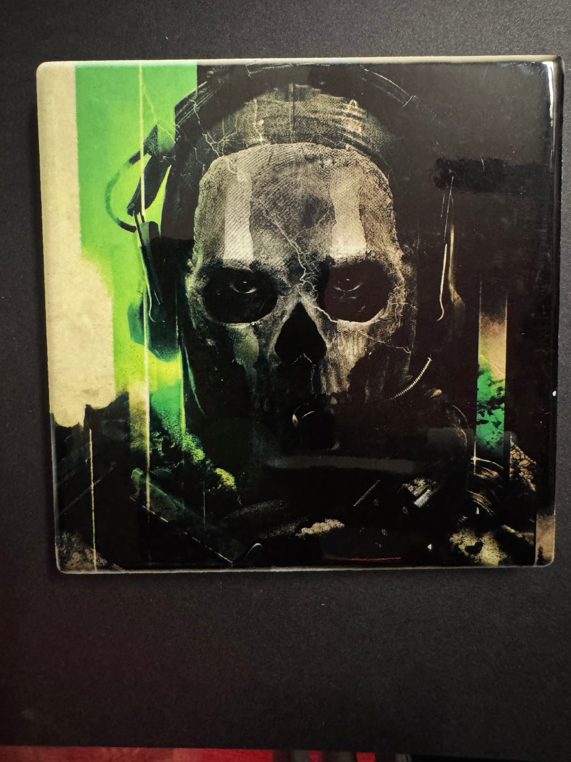 Square ceramic coaster featuring a skull-masked Ghost-inspired tactical character with green accents