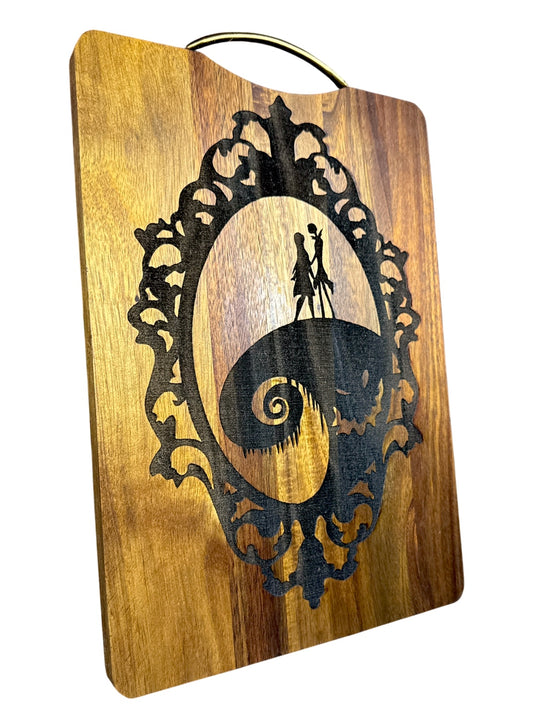 Angled view of Jack and Sally laser engraved acacia cutting board