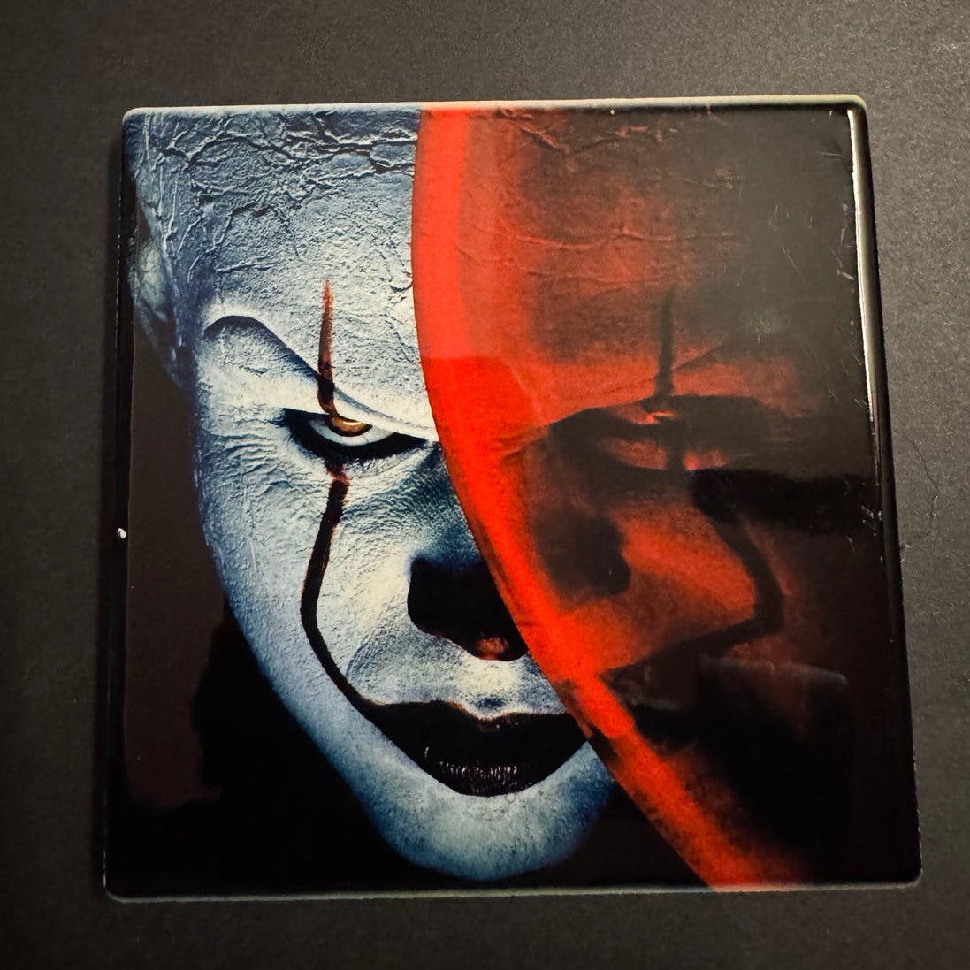 Sinister clown red and blue horror coaster