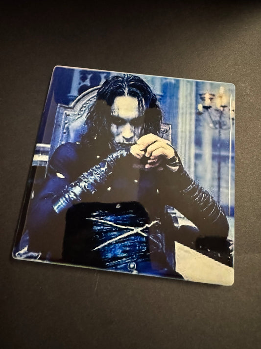 Square ceramic gothic horror coaster featuring a pale long-haired figure in dark clothing against a blue-toned background