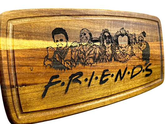Angled view of Horror Friends laser engraved acacia cutting board