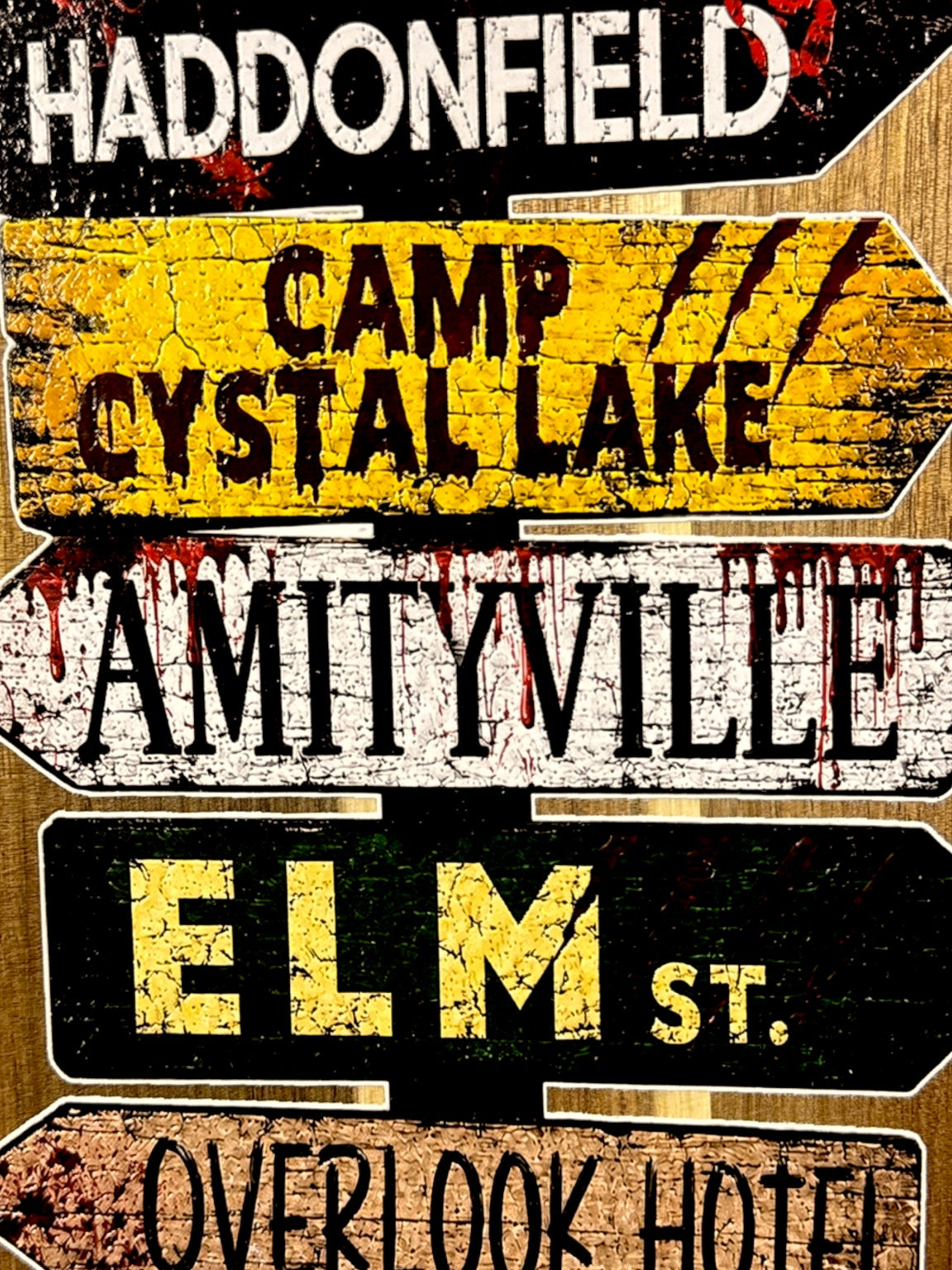 Close up of UV printed horror movie street signs on acacia board