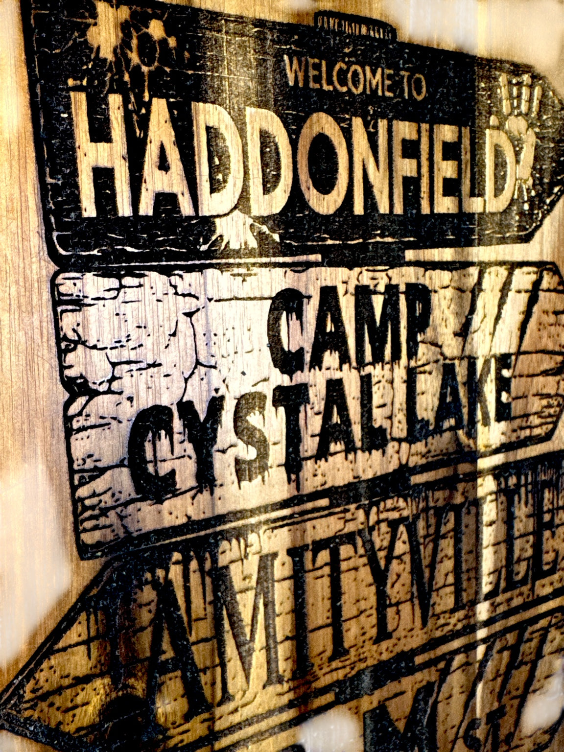 Close detail of Haddonfield Camp Crystal Lake Amityville Elm Street Overlook Hotel Bates Motel engraved signs