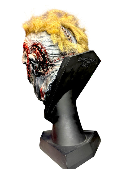 Side view of hand-painted Leatherface horror bust with faux hair and display base