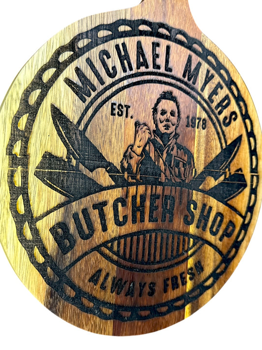 Angled view of Michael Myers Butcher Shop Oopsie engraved acacia board