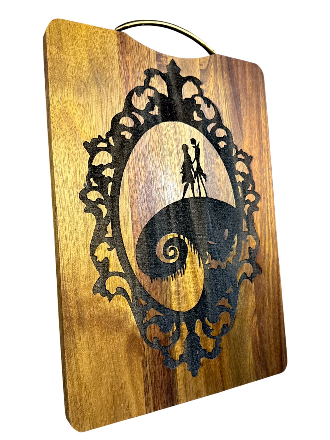 Angled view of Jack and Sally laser engraved acacia cutting board