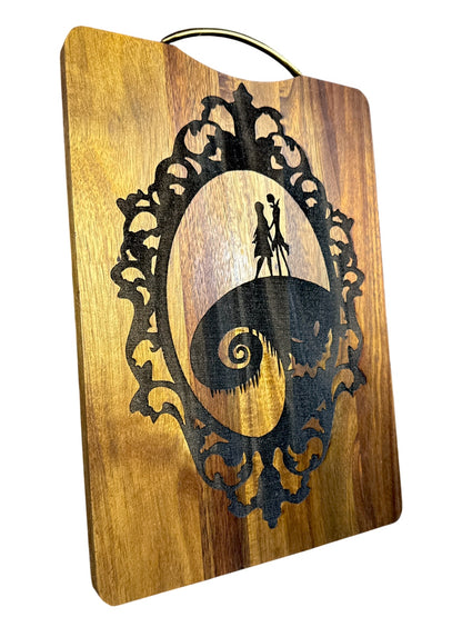 Angled view of Jack and Sally laser engraved acacia cutting board