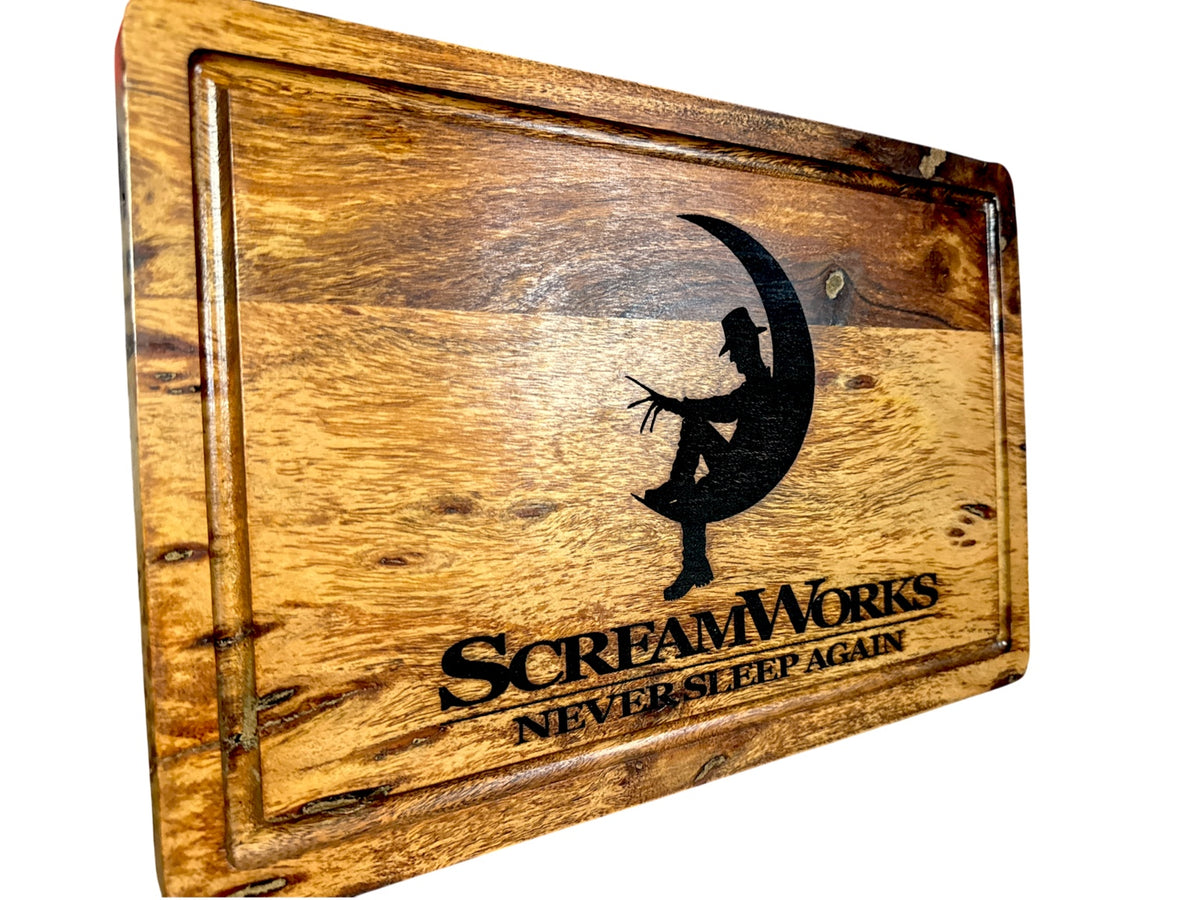 Angled view of ScreamWorks Freddy Krueger inspired acacia cutting board