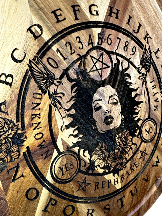 Close detail of occult spirit board engraving on round acacia cutting board